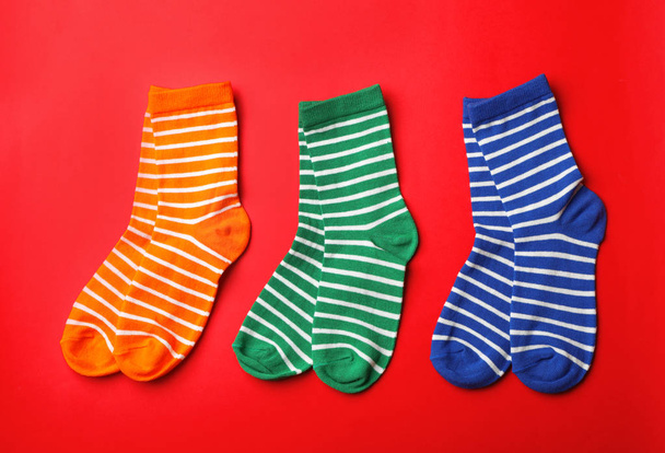 Cute child socks on color background, top view - Фото, изображение