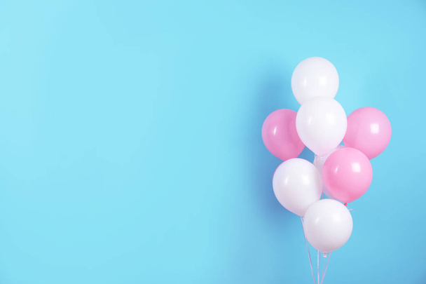 Colorful party balloons on blue background. Space for text - Φωτογραφία, εικόνα