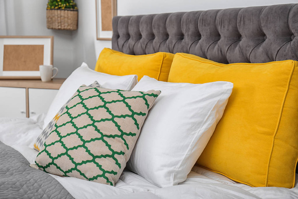 Big bed with soft pillows in stylish room interior - Φωτογραφία, εικόνα
