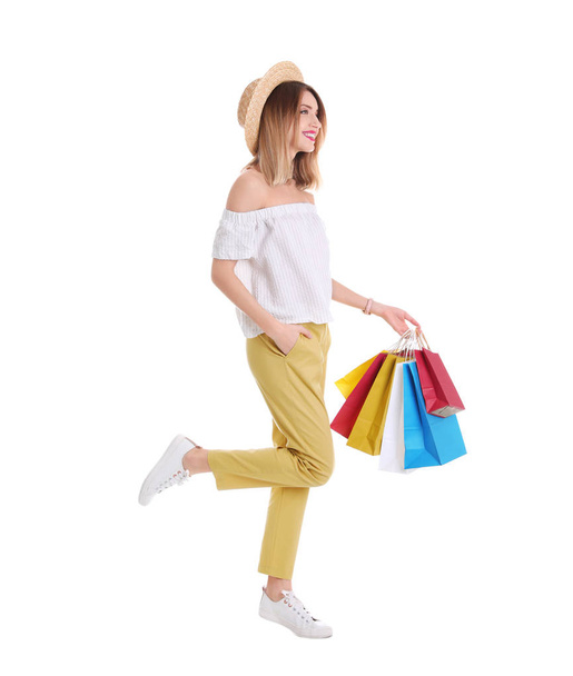 Beautiful young woman with shopping bags on white background - Foto, Bild