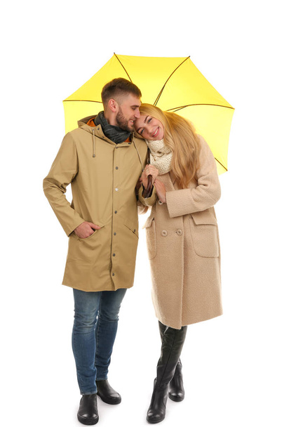 Full length portrait of beautiful couple with umbrella, isolated on white - Foto, Imagen