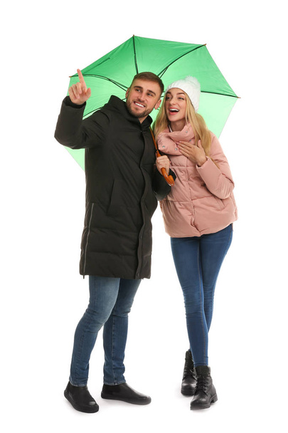 Full length portrait of beautiful couple with umbrella, isolated on white - Fotó, kép