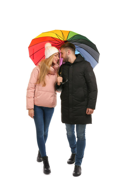Full length portrait of beautiful couple with umbrella, isolated on white - Fotó, kép