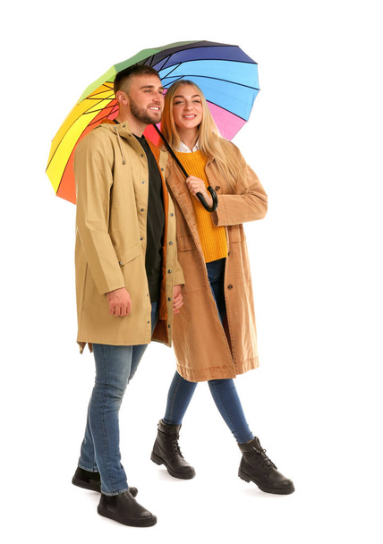 Full length portrait of beautiful couple with umbrella, isolated on white - Foto, afbeelding