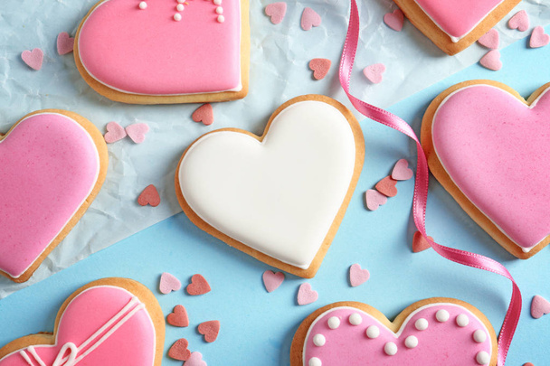 Decorated heart shaped cookies on color background, flat lay - Фото, зображення
