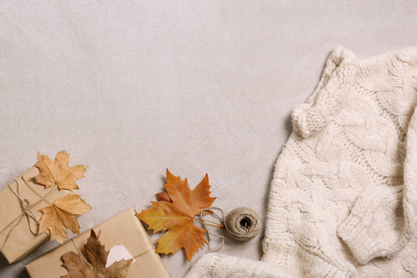Flat lay composition with warm sweater and space for text on gray background - Foto, imagen