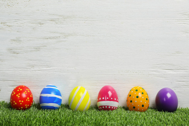 Decorated Easter eggs on green grass. Space for text - Φωτογραφία, εικόνα