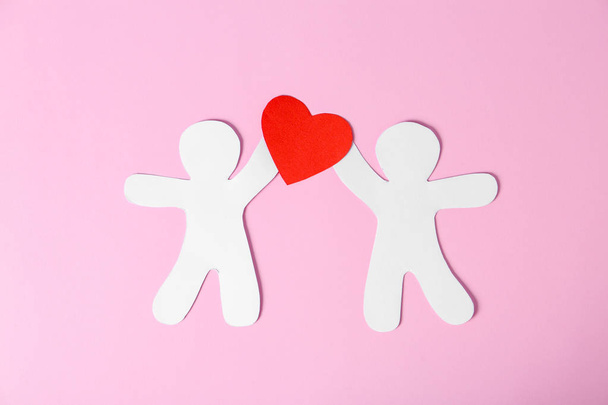Paper people with red heart on color background. Romantic feelings - Фото, зображення