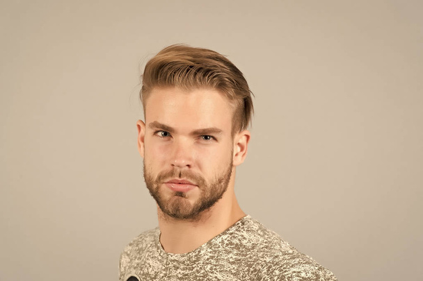 Macho with bearded face, beard. Man with blond hair, haircut. Grooming and hair care in beauty salon, barbershop. Fashion, style and trend concept - Foto, Imagen