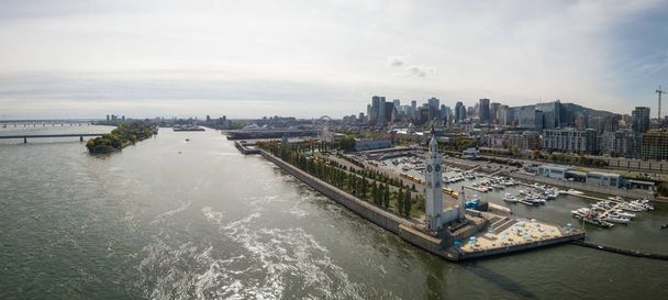 Aerial panoramic view of a modern cityscape during a vibrant day during fall season. Taken in Montreal, Quebec, Canada. - Fotografie, Obrázek