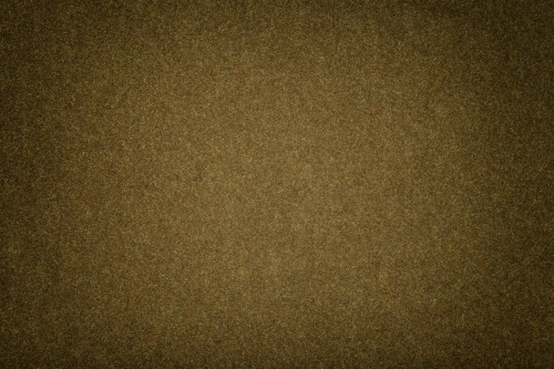 Dark brown matte background of suede fabric, closeup. Velvet texture of seamless olive woolen felt with vignette. - Photo, Image