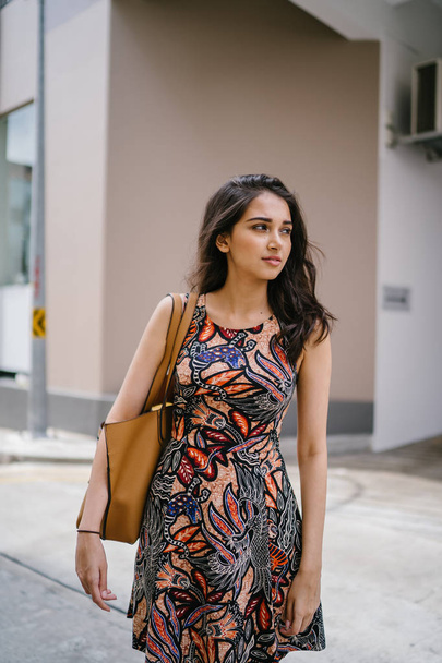 Fashion portrait of a beautiful, young and slim Indian Asian girl in dress posing - Fotó, kép