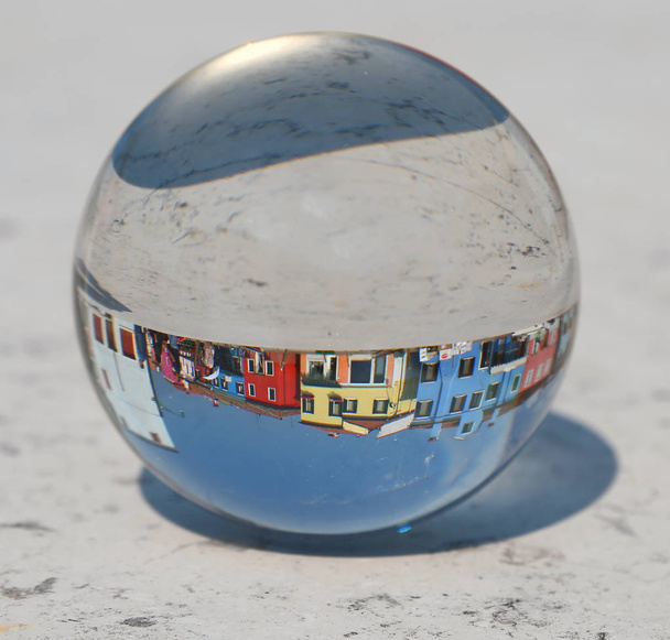 large crystal ball where the colorful houses of the island of Burano are located near Venice in Italy - Photo, Image