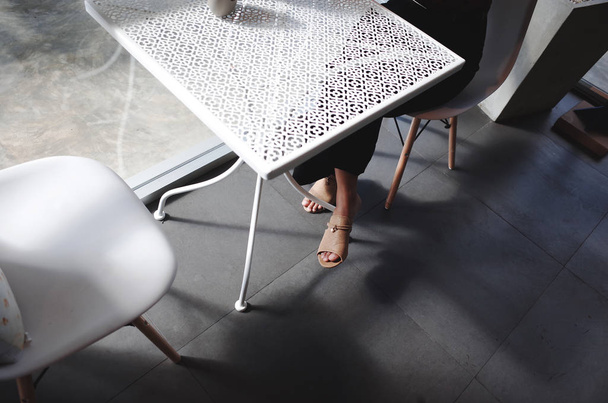 Women sit on chair In office with light and shadow. - Zdjęcie, obraz