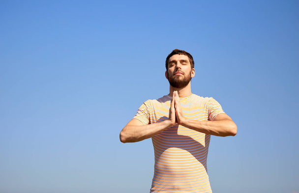 man meditating outdoors over sky - Fotografie, Obrázek