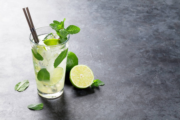 Mojito cocktail on dark stone table. With copy space for your text - Foto, Imagen