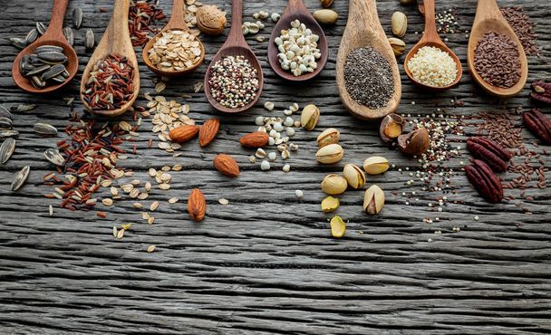Different types of grains and cereals on shabby wooden background - Fotografie, Obrázek