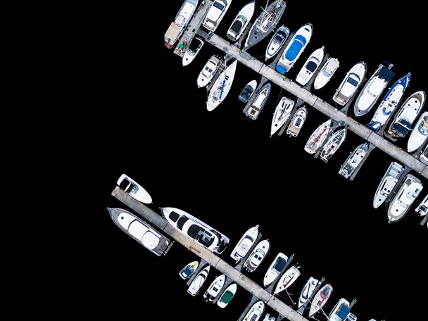 Aerial View by Drone of Yacht Club and Marina. Top view of yacht club. White boats in sea water. Marina dock yachts and small motor boats. Yacht and sailboat is moored at the quay. Parking - Photo, image