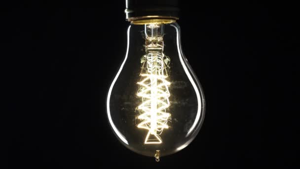 Edisons light bulb illuminates slowly from electric current - Footage, Video