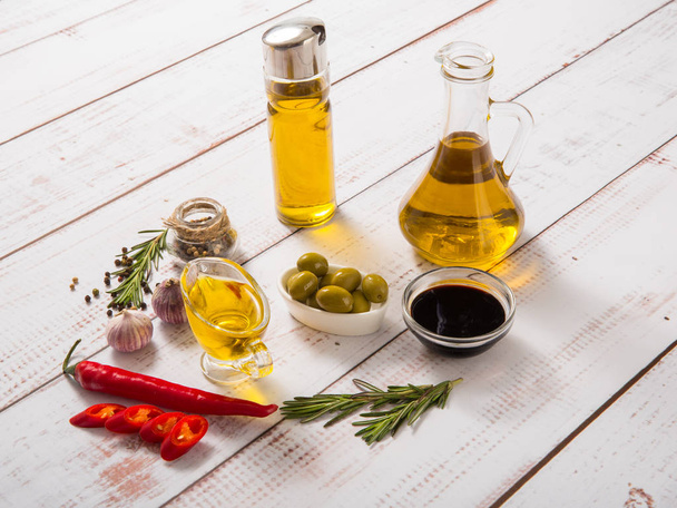 Olive oil with olives on a wooden Board. - Zdjęcie, obraz