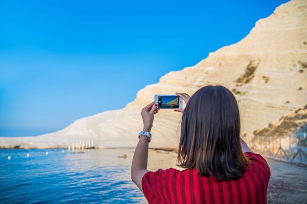 Girl takes a photo of Turkish stairs in Sicily with her iphone - Photo, Image