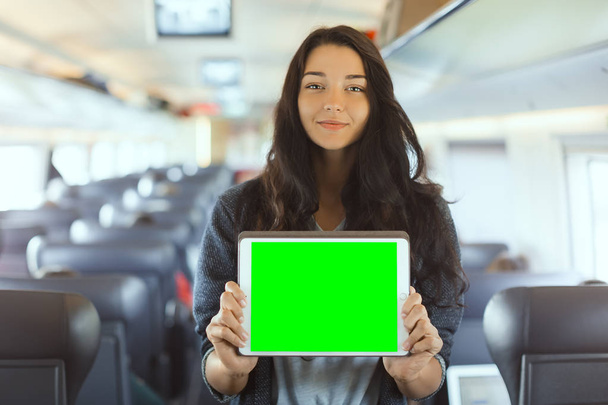 Young woman holding tablet computer while traveling by train - Fotoğraf, Görsel