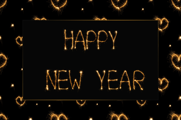 close up view of happy new year light lettering and hearts light signs on black backdrop - Photo, Image