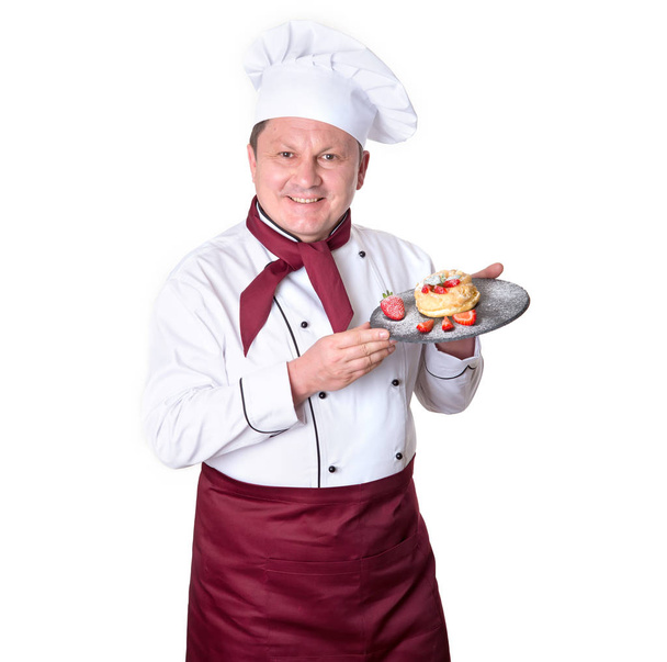 Chef confectioner holds on a tray fresh buns on a white background. Male cook. - Foto, immagini