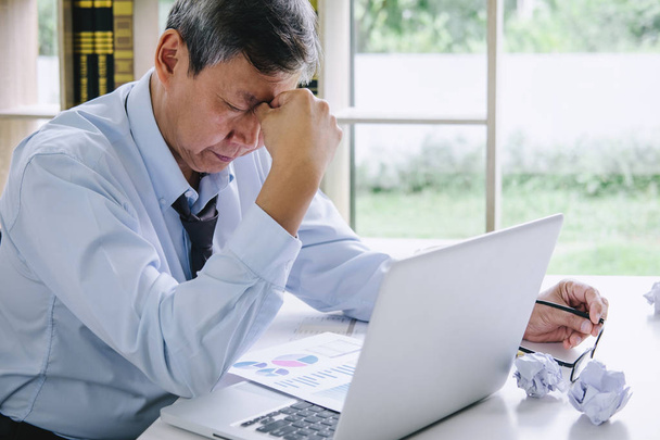 Feeling sick and tired, Senior businessman depressed and exhausted, businessman at his desk frustrated with problems and keeping eyes closed while sitting on office. - 写真・画像