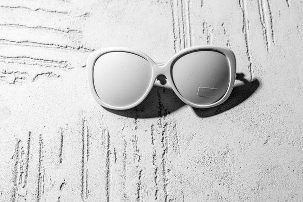 close-up view of decorative white sunglasses on wall in beauty salon - Φωτογραφία, εικόνα