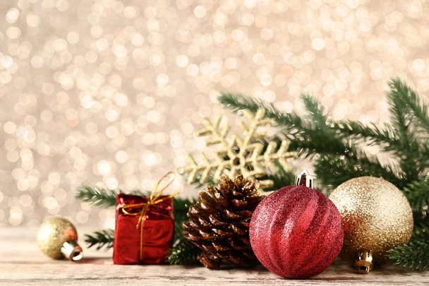Christmas baubles with cones and fir tree branches on bokeh background - Photo, Image