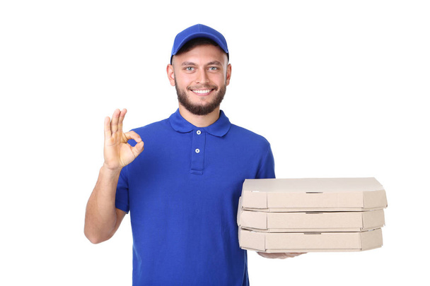 Delivery man with pizza in cardboard boxes isolated on white background - Foto, Bild