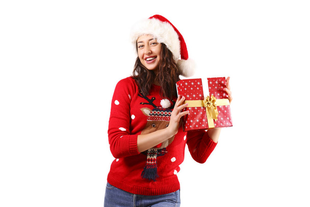 Beautiful smiling young woman wearing knitted sweater celebrating Christmas. Attractive brunette casual female, new years eve. Ugly Christmas sweater concept. Background, copy space, close up portrait - Zdjęcie, obraz