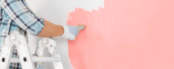 close up of male in gloves painting a wall - Foto, immagini