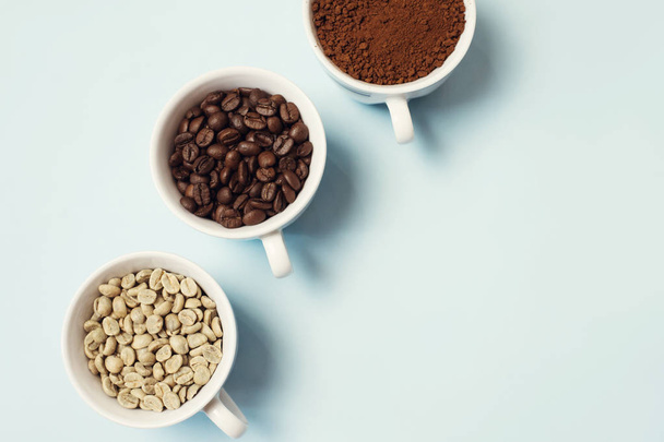 Different types of coffee - ground, grain and unroasted on blue pastel background - Fotoğraf, Görsel