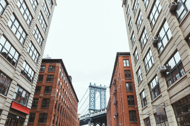 urban scene with buildings and brooklyn bridge in new york city, usa - Photo, Image