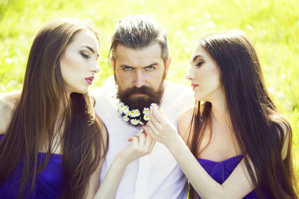 bearded man and women on grass - 写真・画像