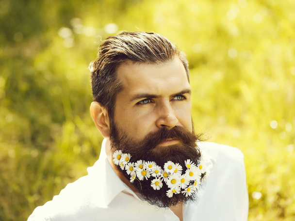 Handsome man with flowers in beard - Foto, Imagen