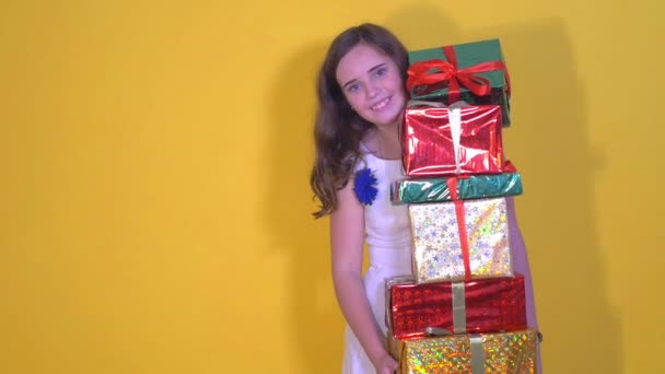 girl in dress drops gift boxes to the floor - Filmati, video