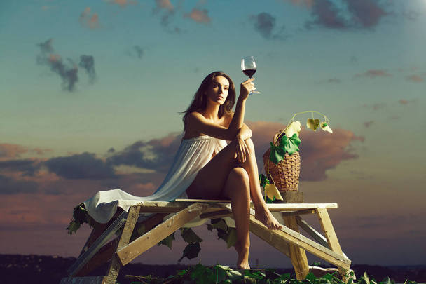 pretty woman with wine over sky - Foto, Imagen