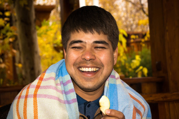 Zavřete Portrét muže těší plátkem jablka jíst venku. Podzimní vibrace - Fotografie, Obrázek