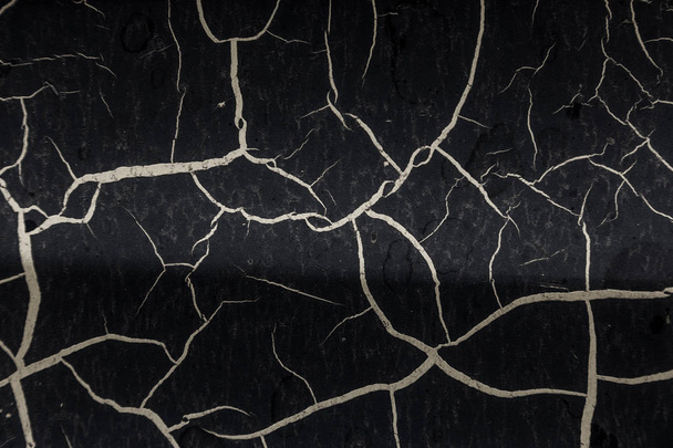Background of old cracked paint. Large cracks on the surface. Close the layers; many paint and paper layers give an abstract texture; macro peeling of the painted surface creates the background - Photo, Image