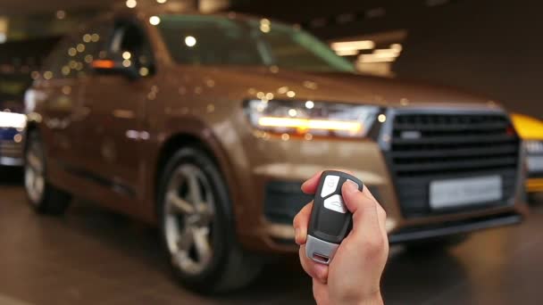 Hand holds and using remote key to unlock a car. Turn signals blinking. Brand New Car. SUV. Allroad - Footage, Video