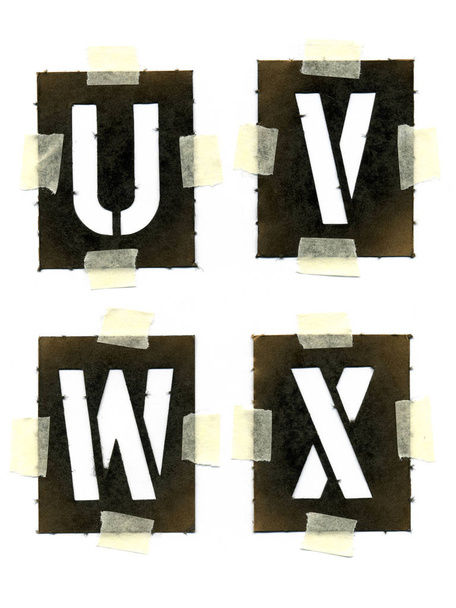 stencil in cartone verniciato attaccati alla carta bianca con nastro adesivo
 - Foto, immagini