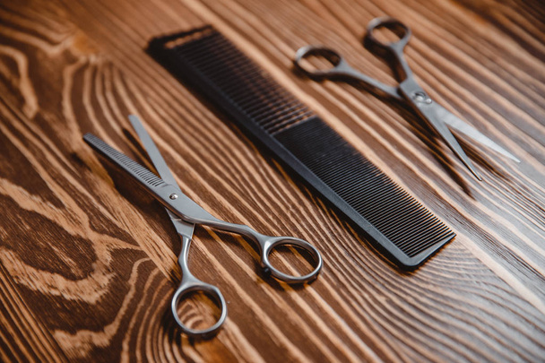 Hairstylist accessories in barber shop wood background. - Foto, Imagen