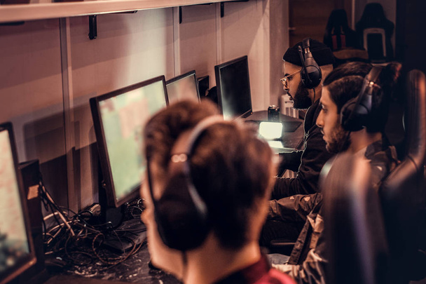 Tým dospívající hráčů hraje v multiplayer videohra na pc v herním klubu. - Fotografie, Obrázek