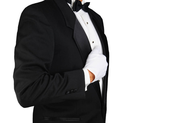 Closeup profile of a man wearing a tuxedo and white gloves holdi - Фото, зображення