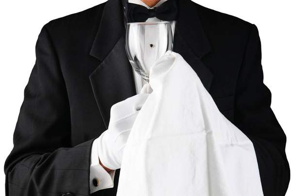 Closeup of a Waiter in Tuxedo Polishing a Wine Glass - Foto, imagen