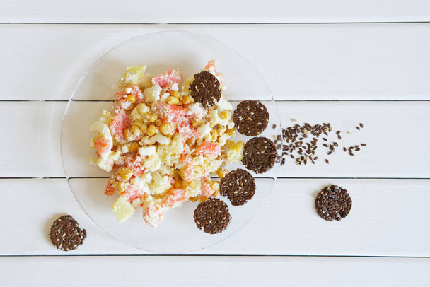 Flax crispbread and salad with pink and pineapple in a transparent plate. - Photo, Image