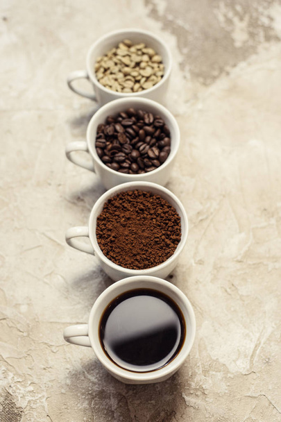 four types of coffee unroasted, bean, ground and one in cup - Fotó, kép